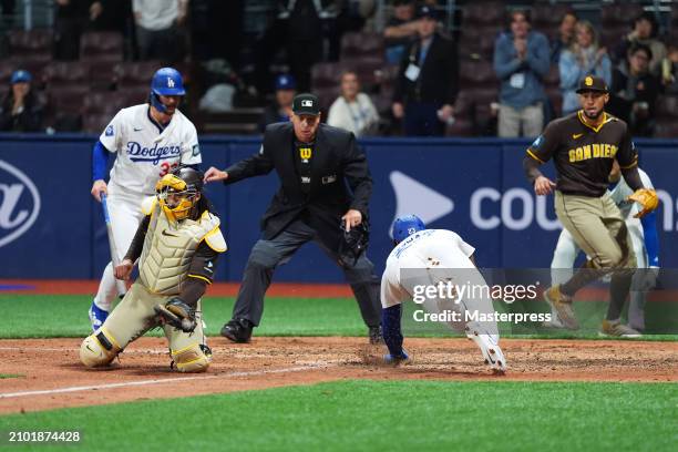 Jason Heyward of the Los Angeles Dodgers slides safely to score a run by a RBI single of Mookie Betts in the 8th inning during the 2024 Seoul Series...