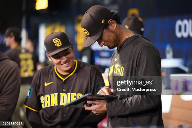 Yuki Matsui and Yu Darvish of the San Diego Padres check a tablet during the 2024 Seoul Series game between San Diego Padres and Los Angeles Dodgers...