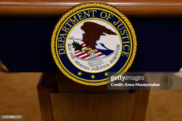 Seal for the Department of Justice is seen on a podium ahead of a news conference with U.S. Attorney General Merrick Garland at the Department of...
