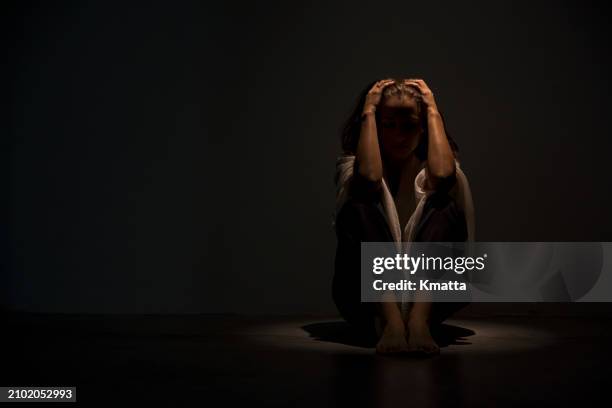 stressed anxious woman sitting on floor hugging knees feeling scared, depression and mental health concept. - suicide imagens e fotografias de stock