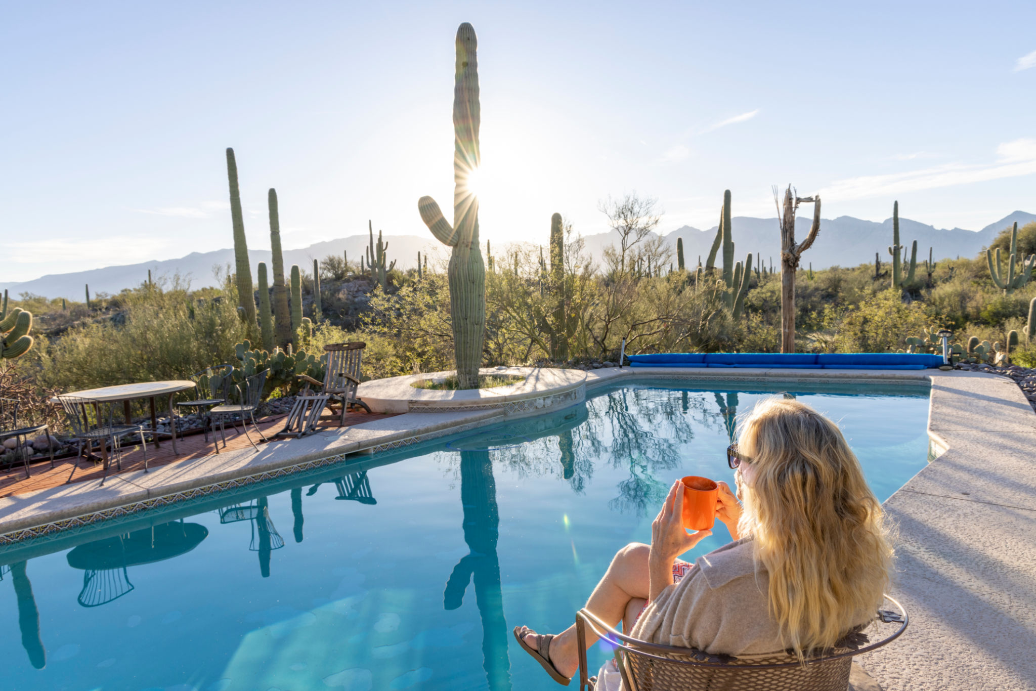 Mature woman relaxes by swimming pool Mature woman relaxes by swimming pool