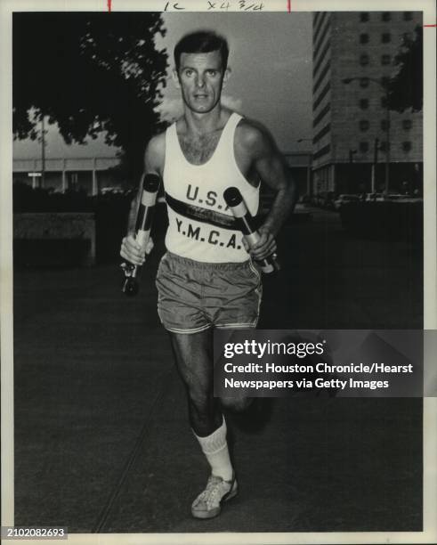 Vocal Student of Michael Lawrence, Bud Abney of 3840 Underwood, a voice student, takes off from City Hall Thursday evening as lead runner on the...