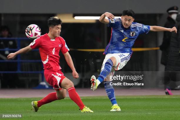 Yukinari Sugawara of Japan and Pom Hyok Kim of North Korea compete for the ball during the FIFA World Cup Asian 2nd qualifier match between Japan and...