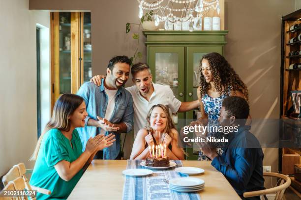 happy friends celebrating a birthday party with cake - gala table stock pictures, royalty-free photos & images