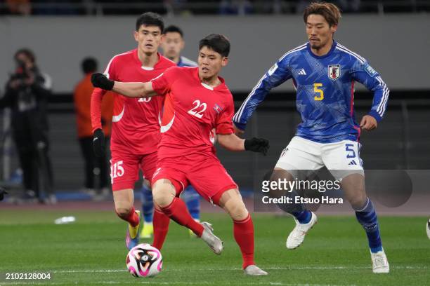 Kim Kuk-Bom of North Korea in action under pressure from Hidemasa Morita of Japan during the FIFA World Cup Asian 2nd qualifier match between Japan...