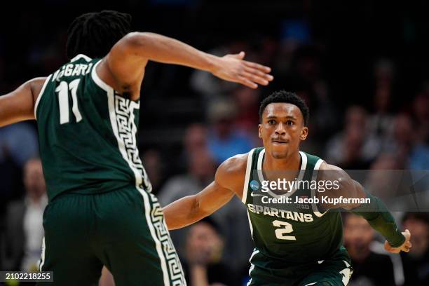 Tyson Walker of the Michigan State Spartans high-fives A.J. Hoggard against the Mississippi State Bulldogs during the first half in the first round...