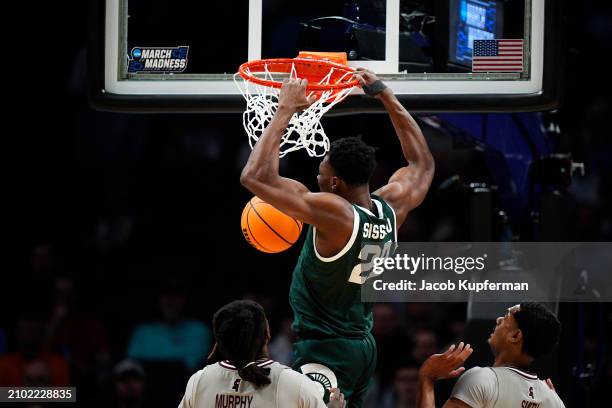 Mady Sissoko of the Michigan State Spartans dunks the ball against the Mississippi State Bulldogs during the first half in the first round of the...