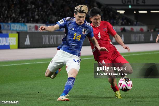 Daiki Hashioka of Japan and Pom Hyok Kim of North Korea compete for the ball during the FIFA World Cup Asian 2nd qualifier match between Japan and...