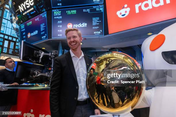 Reddit CEO Steve Huffman stands on the floor of the New York Stock Exchange after ringing a bell on the floor setting the share price at $47 in its...