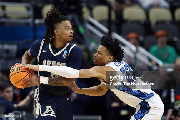 Trey Alexander of the Creighton Bluejays defends against Greg Tribble of the Akron Zips in the first half in the first round of the NCAA Men's...