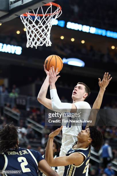 Ryan Kalkbrenner of the Creighton Bluejays takes a shot over Enrique Freeman of the Akron Zips in the first half of their game in the first round of...