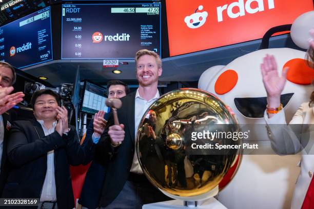 Reddit CEO Steve Huffman stands on the floor of the New York Stock Exchange while ringing a bell on the floor setting the share price at $47 in its...