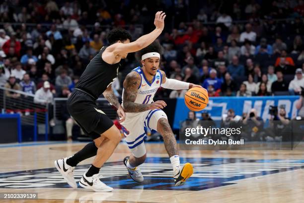 Roddie Anderson III of the Boise State Broncos dribbles the ball while being guarded by KJ Simpson of the Colorado Buffaloes in the first half in the...