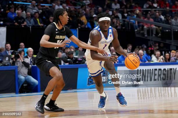 Mar Stanley of the Boise State Broncos dribbles the ball while being guarded by Cody Williams of the Colorado Buffaloes in the first half in the...