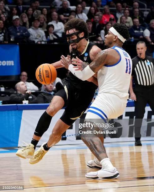 Vonne Hadley of the Colorado Buffaloes dribbles the ball while being guarded by Chibuzo Agbo of the Boise State Broncos in the second half in the...