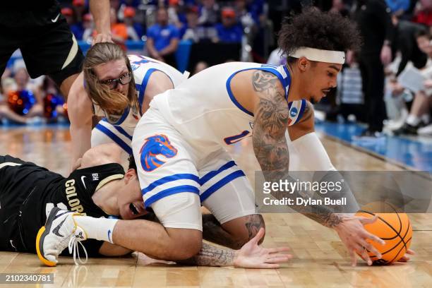 Roddie Anderson III of the Boise State Broncos and KJ Simpson of the Colorado Buffaloes battle for a loose ball in the first half in the First Four...