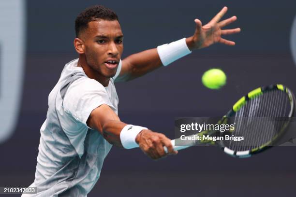 Felix Auger-Aliassime of Canada returns a shot to Adam Walton of Australia during his men's singles match during the Miami Open at Hard Rock Stadium...