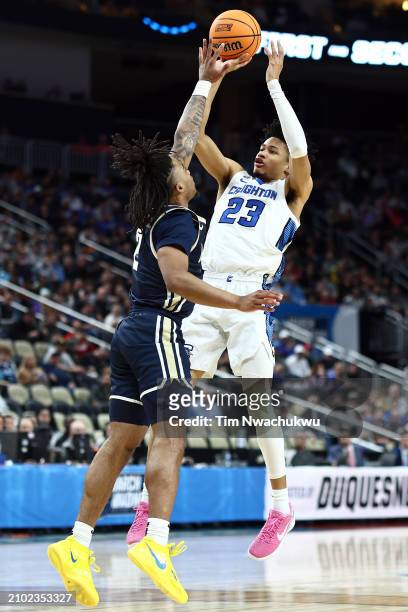 Trey Alexander of the Creighton Bluejays takes a shot over Greg Tribble of the Akron Zips in the first half in the first round of the NCAA Men's...