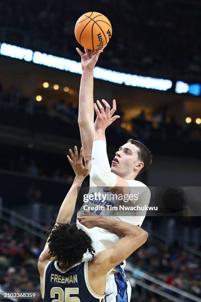 Ryan Kalkbrenner of the Creighton Bluejays takes a shot over Enrique Freeman of the Akron Zips in the first half of their game in the first round of...