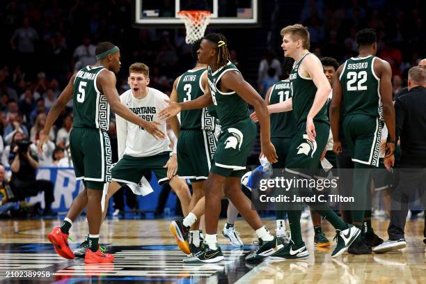 Tre Holloman of the Michigan State Spartans celebrates with his teammates against the Mississippi State Bulldogs during the second half in the first...