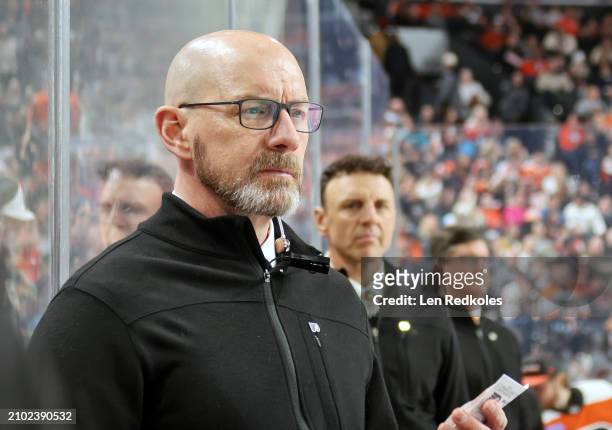 Assistant coach of the Philadelphia Flyers Darryl Williams watches the play on the ice during the first period against the San Jose Sharks at the...