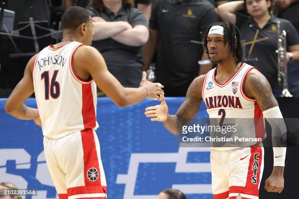 Caleb Love and Keshad Johnson of the Arizona Wildcats celebrate during the first half against the Long Beach State 49ers in the first round of the...