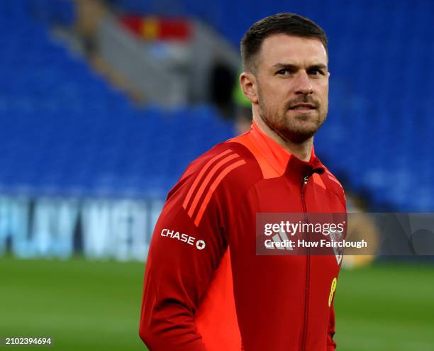 Aaron Ramsay Captain of Wales walks onto the pitch ahead of the UEFA EURO 2024 Play-Offs Semi-final between Wales and Finland at Cardiff City Stadium...