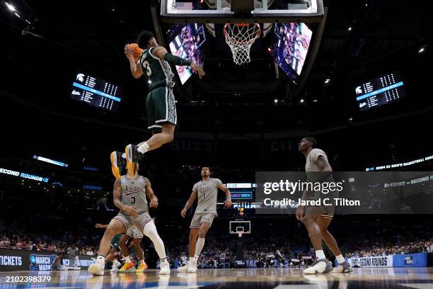 Jaden Akins of the Michigan State Spartans dunks the ball against the Mississippi State Bulldogs during the second half in the first round of the...