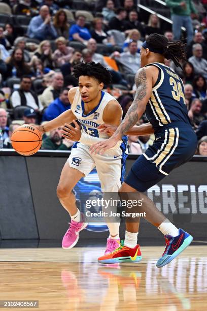 Trey Alexander of the Creighton Bluejays drives to the basket against Nate Johnson of the Akron Zips int he second half in the first round of the...