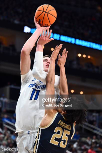 Ryan Kalkbrenner of the Creighton Bluejays takes a shot over Enrique Freeman of the Akron Zips in the second half in the first round of the NCAA...