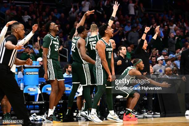 Michigan State Spartans react from the bench during the second half of a basketball game against the Mississippi State Bulldogs at Spectrum Center on...