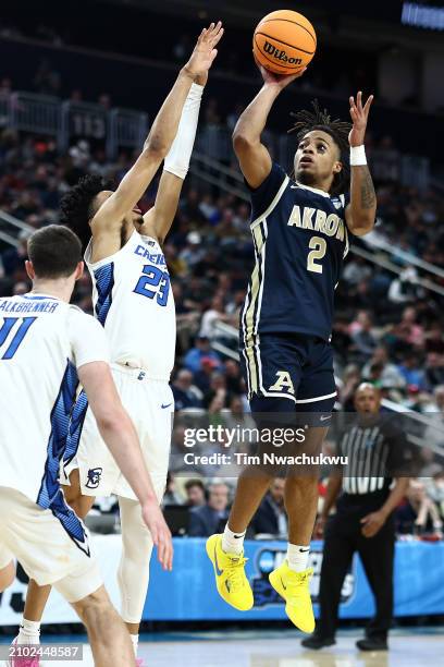 Greg Tribble of the Akron Zips takes a shot over Trey Alexander of the Creighton Bluejays in the second half in the first round of the NCAA Men's...