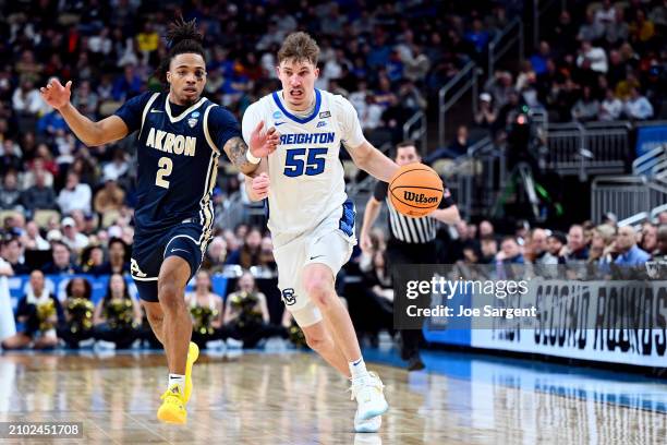 Baylor Scheierman of the Creighton Bluejays brings the ball up the floor as Greg Tribble of the Akron Zips defends in the second half in the first...