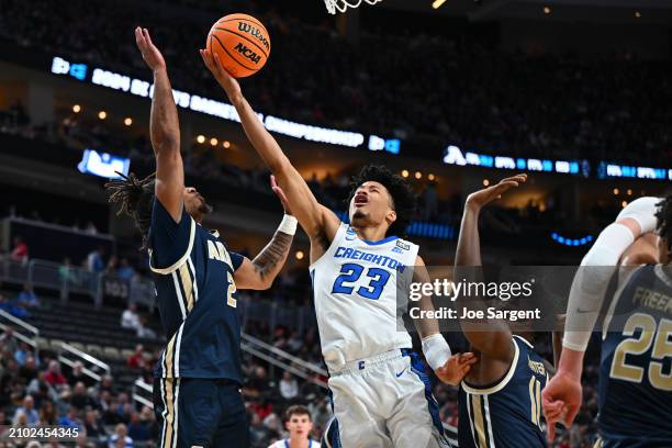 Trey Alexander of the Creighton Bluejays is fouled by Greg Tribble of the Akron Zips in the second half in the first round of the NCAA Men's...