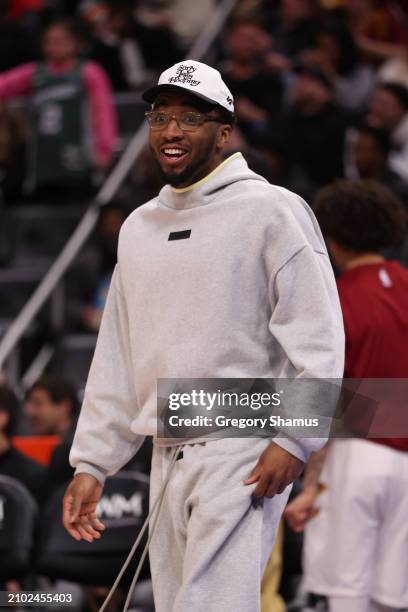 Donovan Mitchell of the Cleveland Cavaliers looks on from the bench while playing the Detroit Pistons at Little Caesars Arena on March 01, 2024 in...