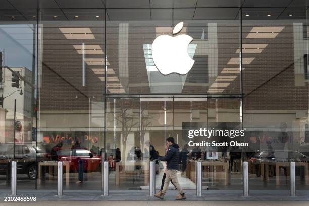 The Apple logo hangs in front of an Apple store on March 21, 2024 in Chicago, Illinois. The Justice Department today sued Apple claiming the iPhone...