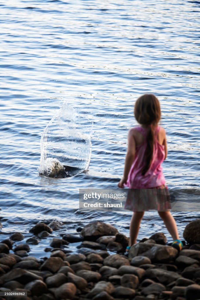 Girl Throws Rocks in Lake