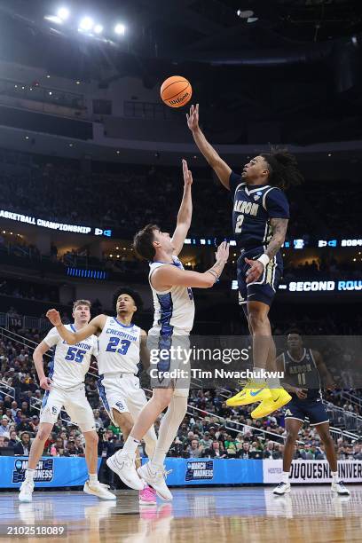 Greg Tribble of the Akron Zips takes a shot over Francisco Farabello of the Creighton Bluejays in the second half in the first round of the NCAA...