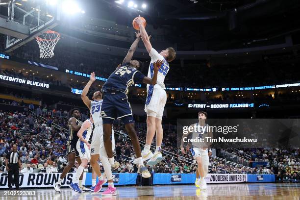 Baylor Scheierman of the Creighton Bluejays and Ali Ali of the Akron Zips jump for a rebound in the second half in the first round of the NCAA Men's...