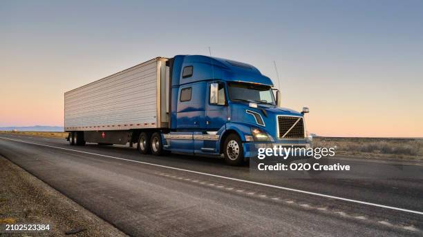 long haul semi truck on a western usa interstate highway - truck stockfoto's en -beelden