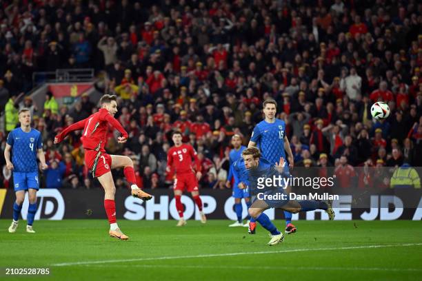 David Brooks of Wales scores his team's first goal during the UEFA EURO 2024 Play-Offs Semi-final match between Wales and Finland at Cardiff City...