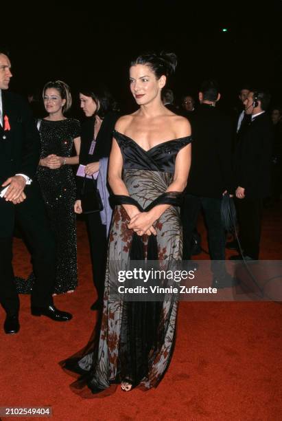 American actress Sandra Bullock, wearing an off-shoulder evening gown, attends the 25th People's Choice Awards, held at the Pasadena Civic Auditorium...