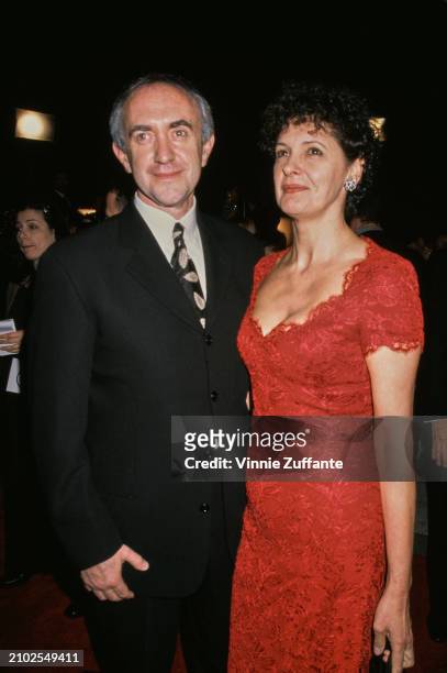 Britsh actor Jonathan Pryce and British actress Kate Fahy attend the Los Angeles premiere of 'Tomorrow Never Dies', held at the Dorothy Chandler...