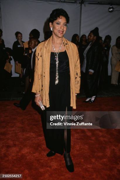 American actress Phylicia Rashad, wearing a black outfit beneath an orange-and-black jacket, with a beaded necklace, attends the 29th NAACP Image...