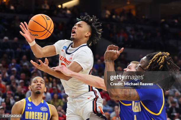 Terrence Shannon Jr. #0 of the Illinois Fighting Illini is fouled by Riley Minix of the Morehead State Eagles during the first half in the first...