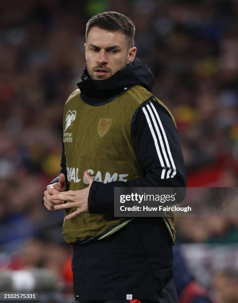 Aaron Ramsay of Wales warms up during the UEFA EURO 2024 Play-Offs Semi-final between Wales and Finland at Cardiff City Stadium on March 21, 2024 in...