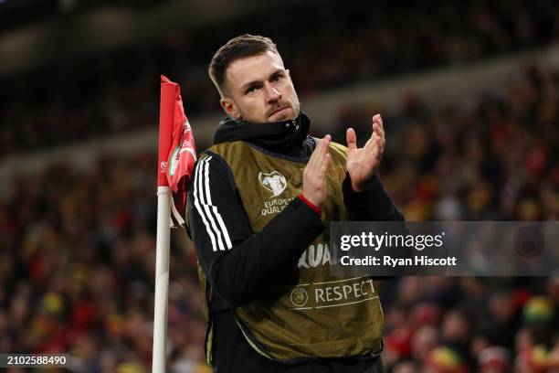 Aaron Ramsey of Wales applauds the fans as he warms up during the UEFA EURO 2024 Play-Offs Semi-final match between Wales and Finland at Cardiff City...