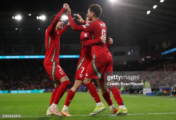 Brennan Johnson of Wales celebrates scoring his team's third goal with Neco Williams and David Brooks during the UEFA EURO 2024 Play-Offs Semi-final...