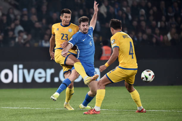 Fotis Ioannidis of Greece is challenged by Temirlan Yerlanov and Marat Bystrov of Kazakhstan during the UEFA EURO 2024 Play-Offs semifinal match...