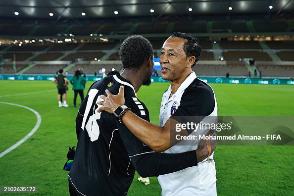 Quillan Roberts of Guyana is embraced by Pedro Brito, Head Coach of